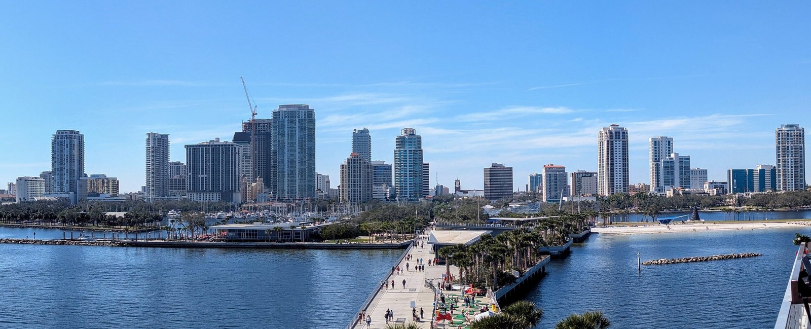 Downtown St. Petersburg skyline and waterfront viewed from St. Pete Pier under a clear blue sky