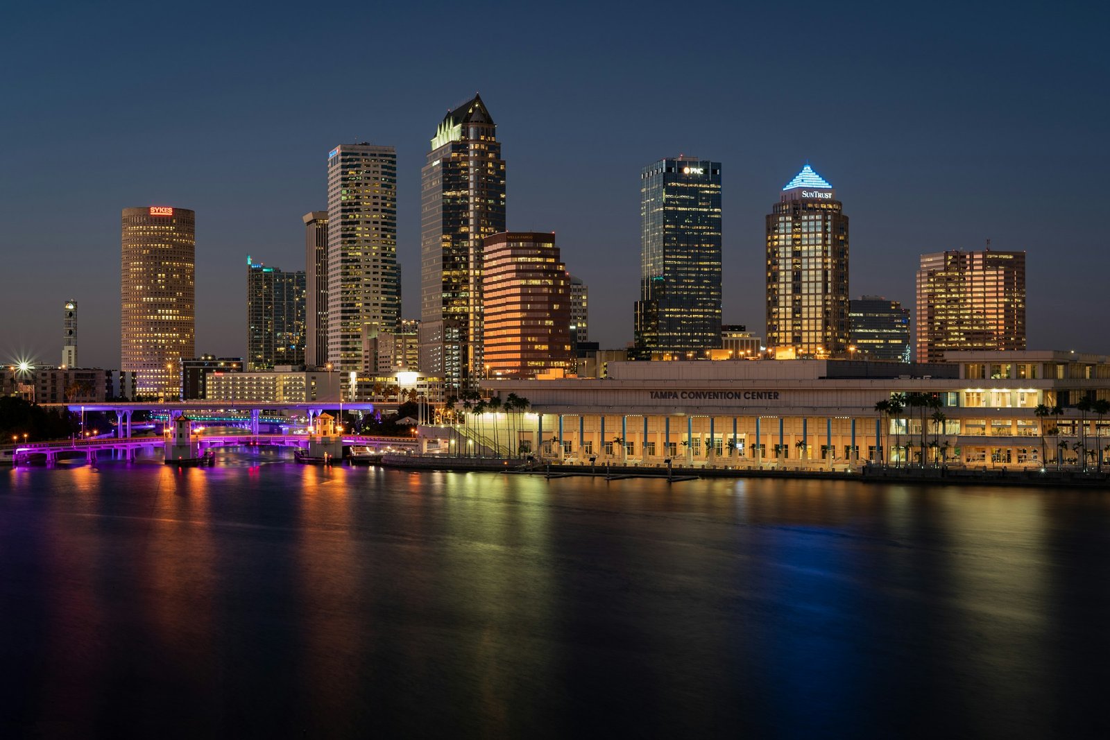 Downtown Tampa skyline and waterfront illuminated at dusk